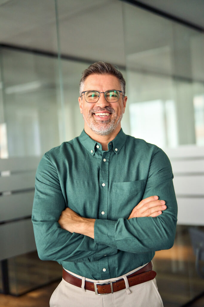 smiling older male in a green button down shirt